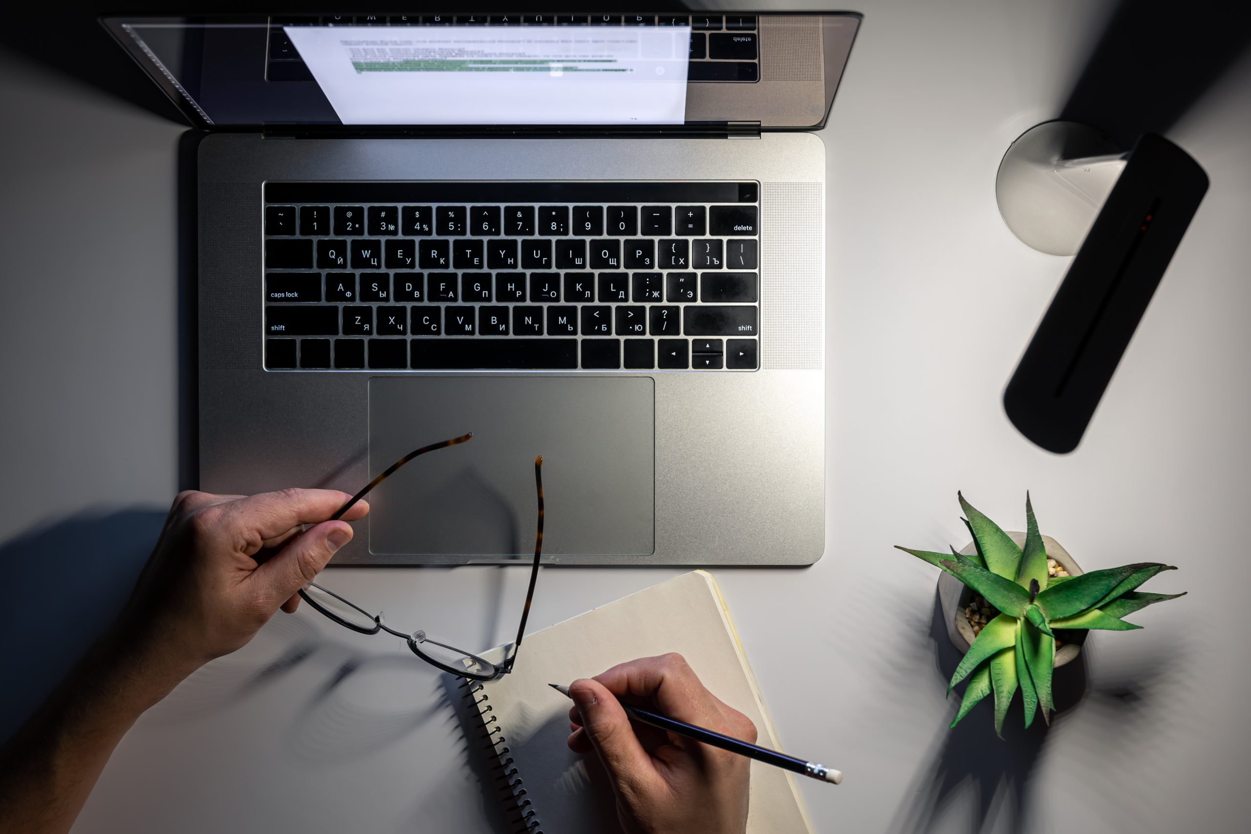 A man works at a laptop at night, night work, deadline, top view.